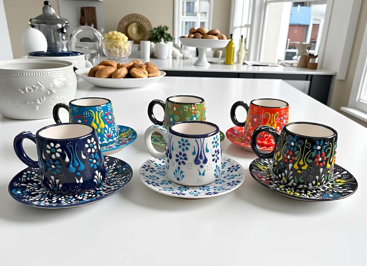 Six hand-painted espresso cups with saucers in bright floral patterns