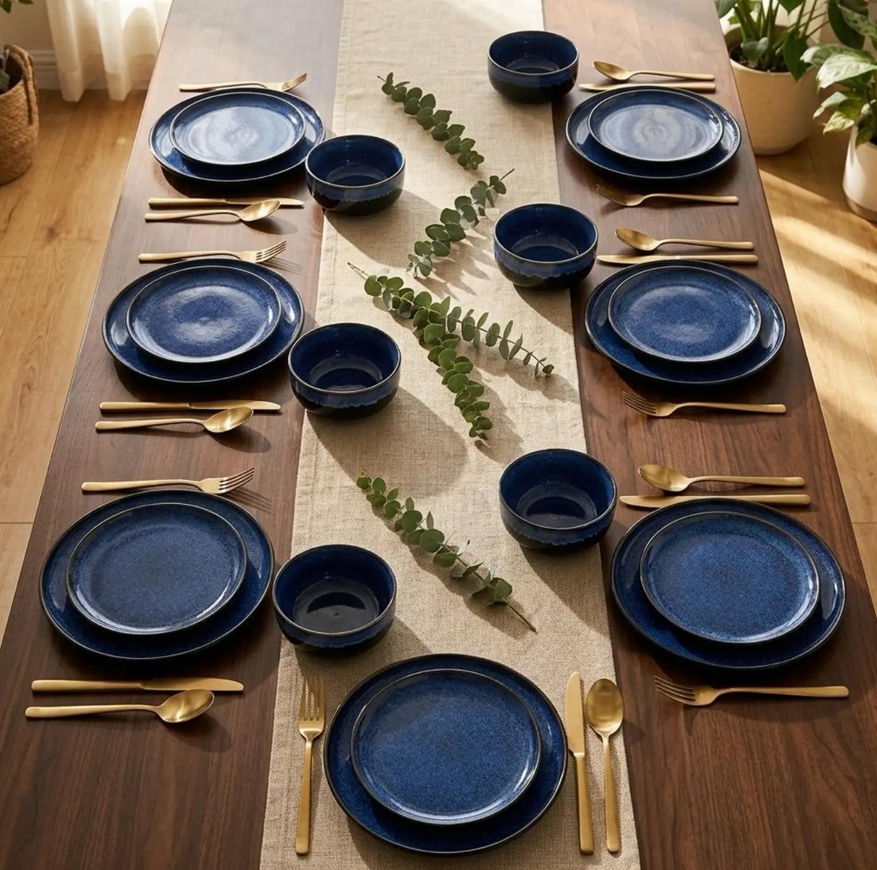 Navy blue stoneware dinner set laid out for six on a walnut table