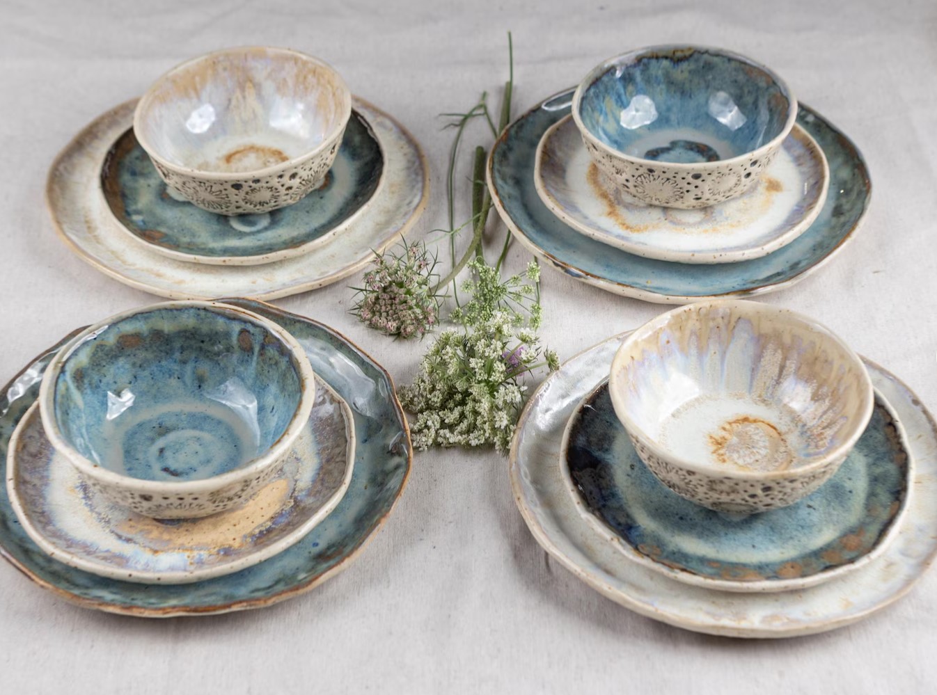 Handmade blue and cream glazed place settings with plates and bowls